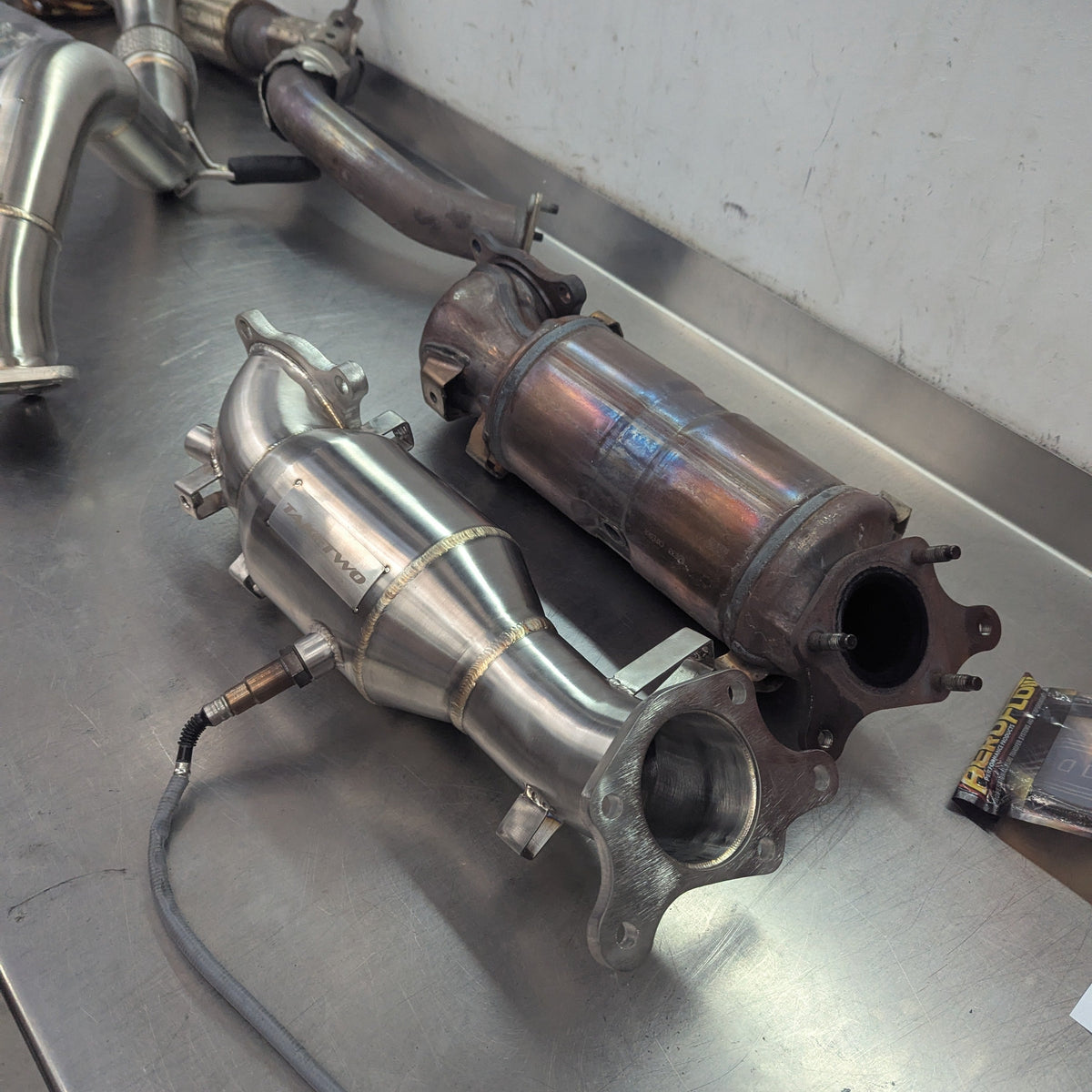 Exhaust pipes and catalytic converters on a metal surface